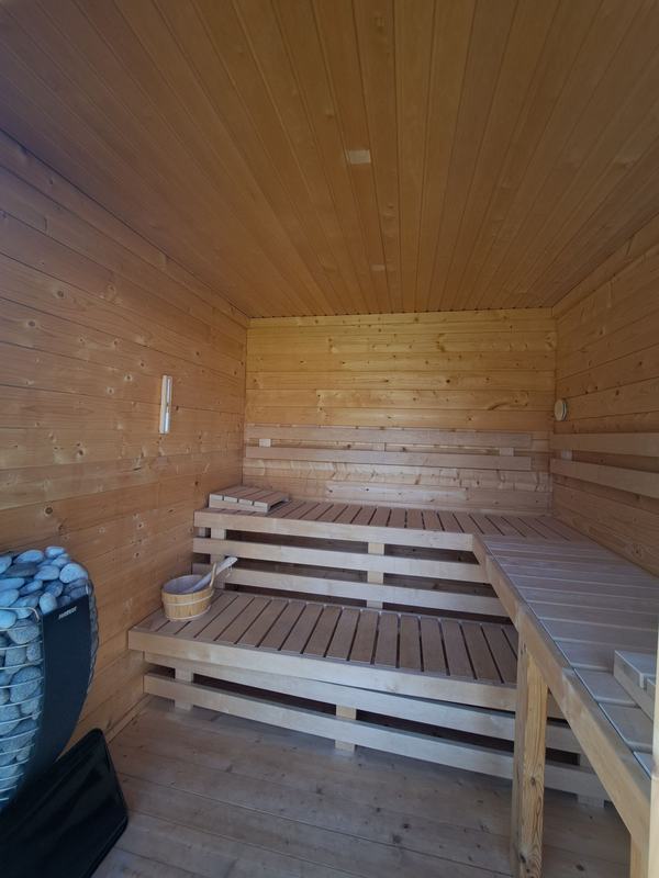 Saunakabine mit Holzbänken und Ofen